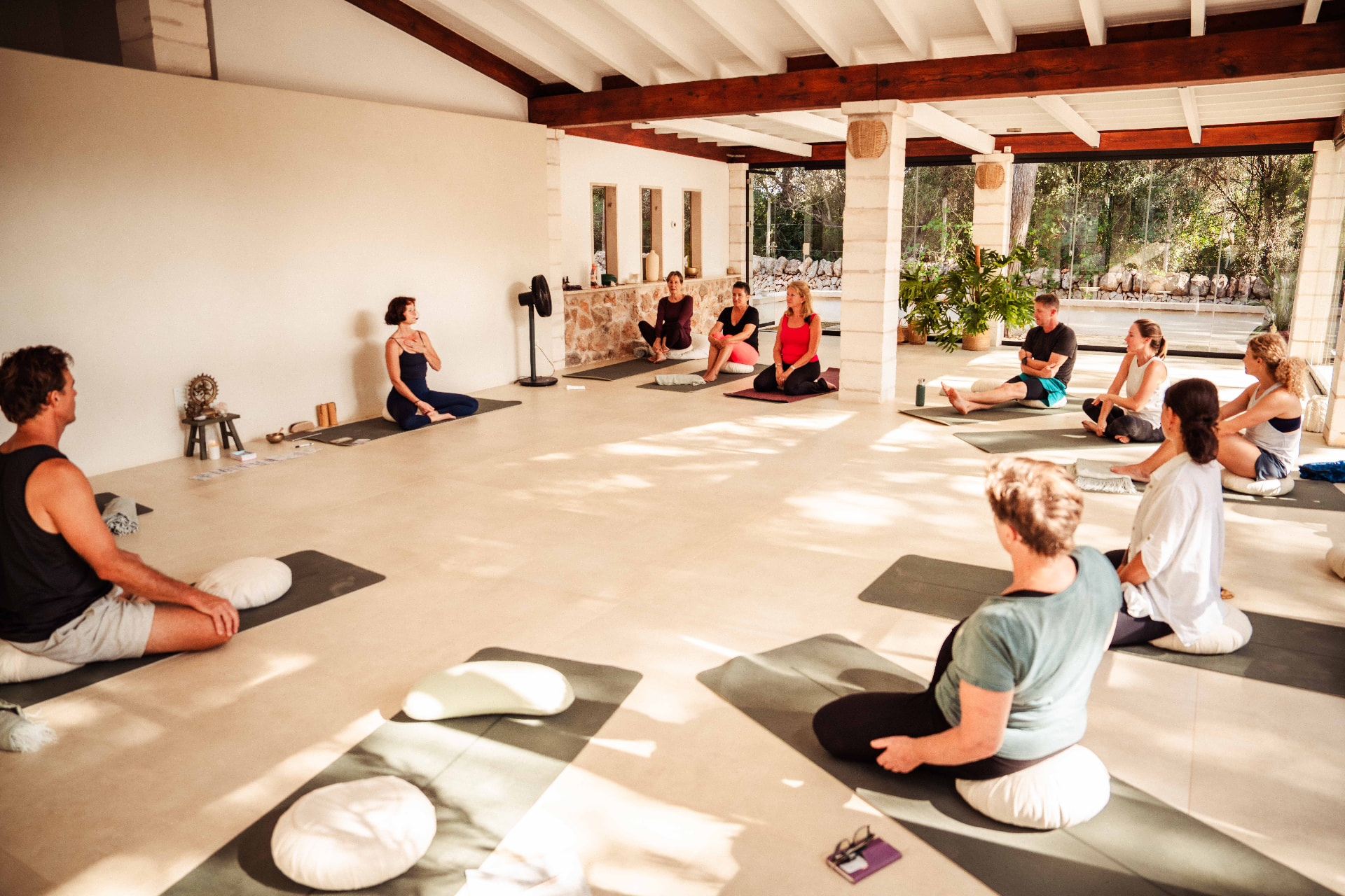 A group Spiral Alignment class seated together in a bright studio