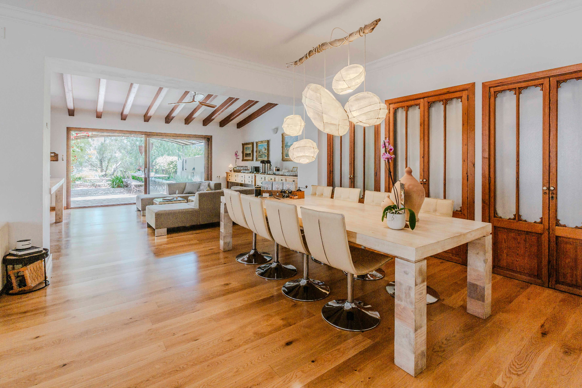 The villa's dining room with a long wooden table and paper lanterns