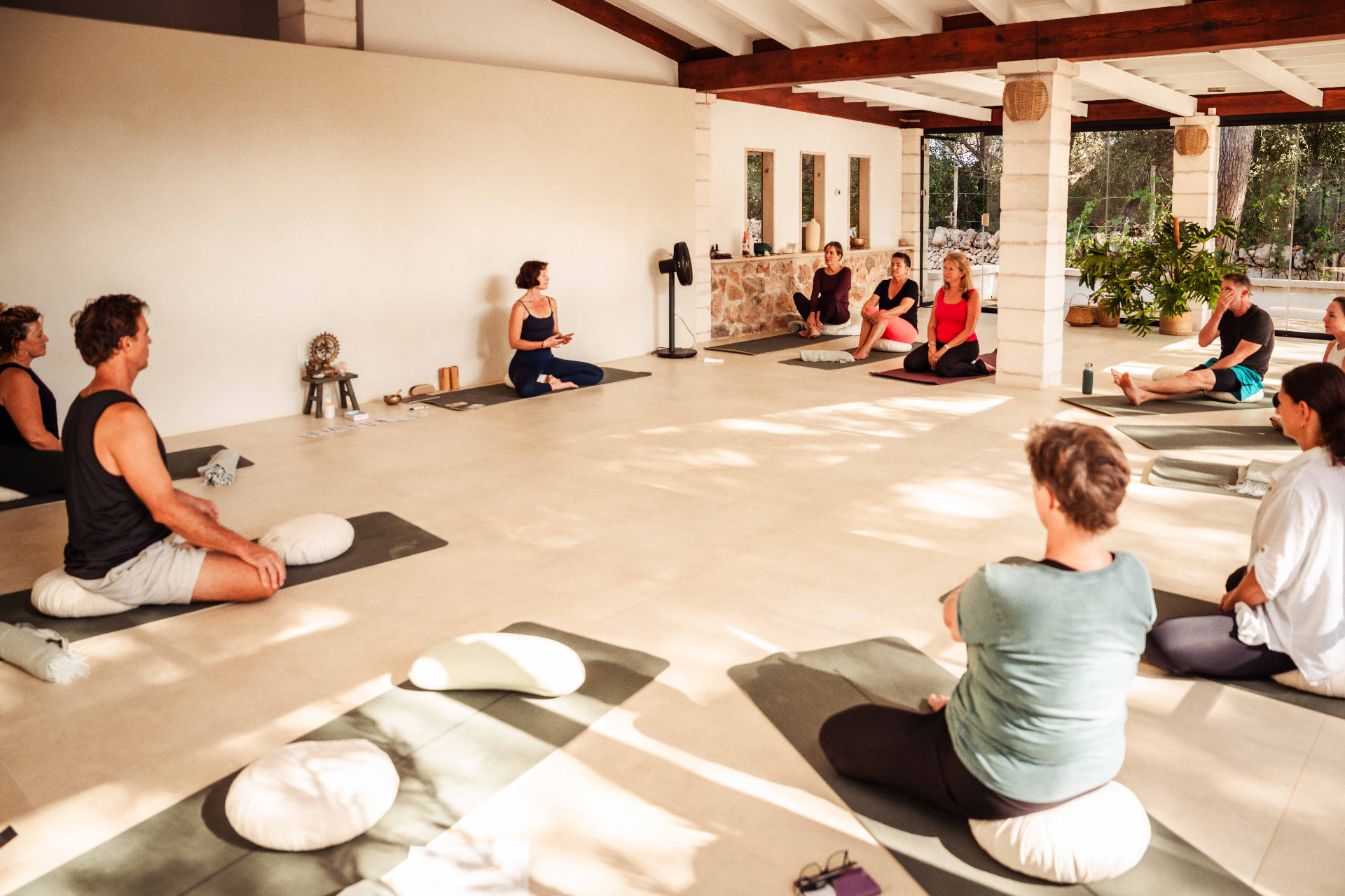A group practising together in the bright stone-walled studio