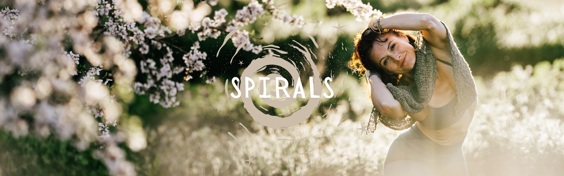 Saskia spiralling beneath blossom trees in the spring sun
